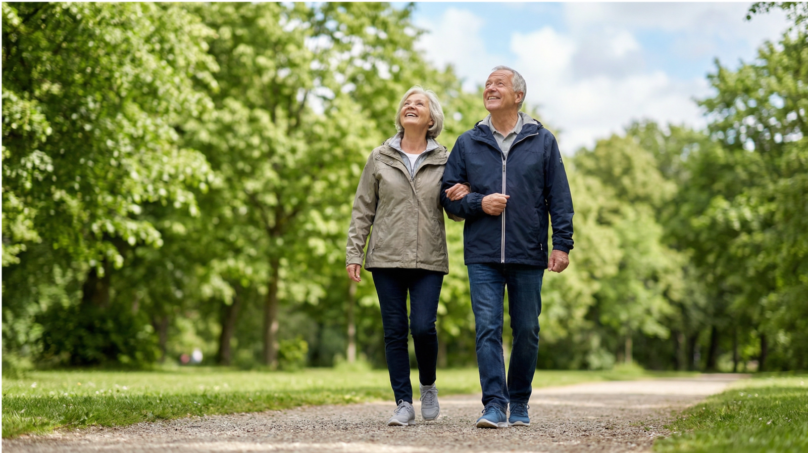 Active senior couple walking in park